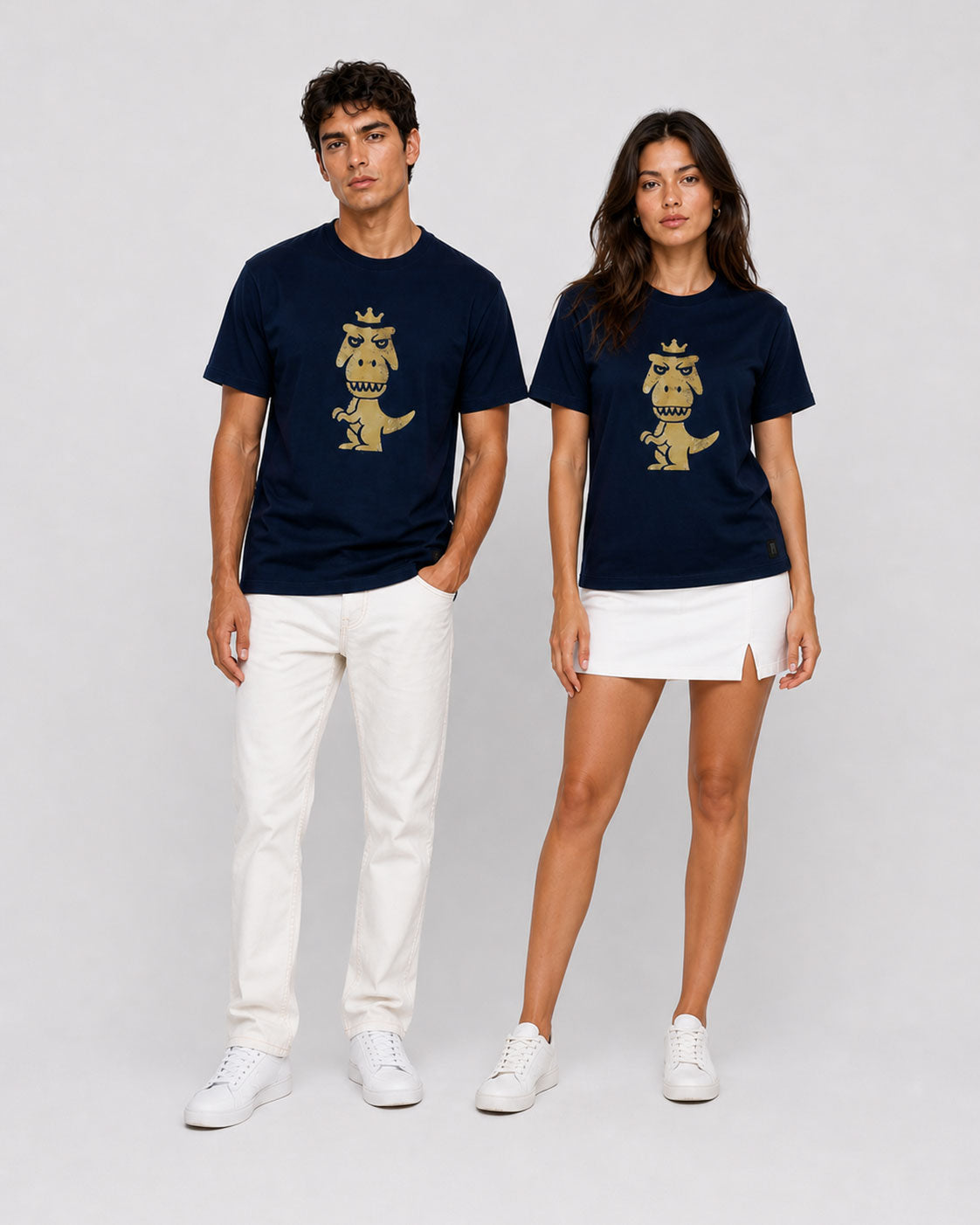 Man and woman wearing matching navy blue Regno T-Rex Aurum pima cotton tees with vintage gold graphic, couple outfit idea his and hers streetwear