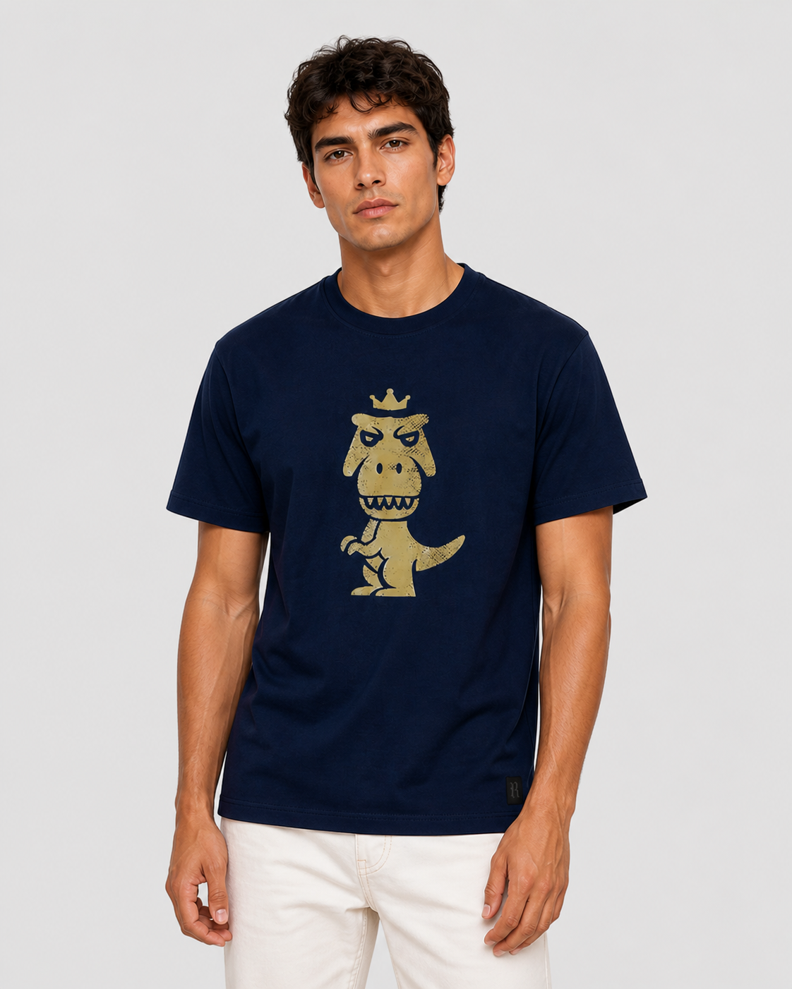 Man wearing navy blue Regno T-Rex Aurum pima cotton graphic tee with vintage gold T-Rex design, upper body shot