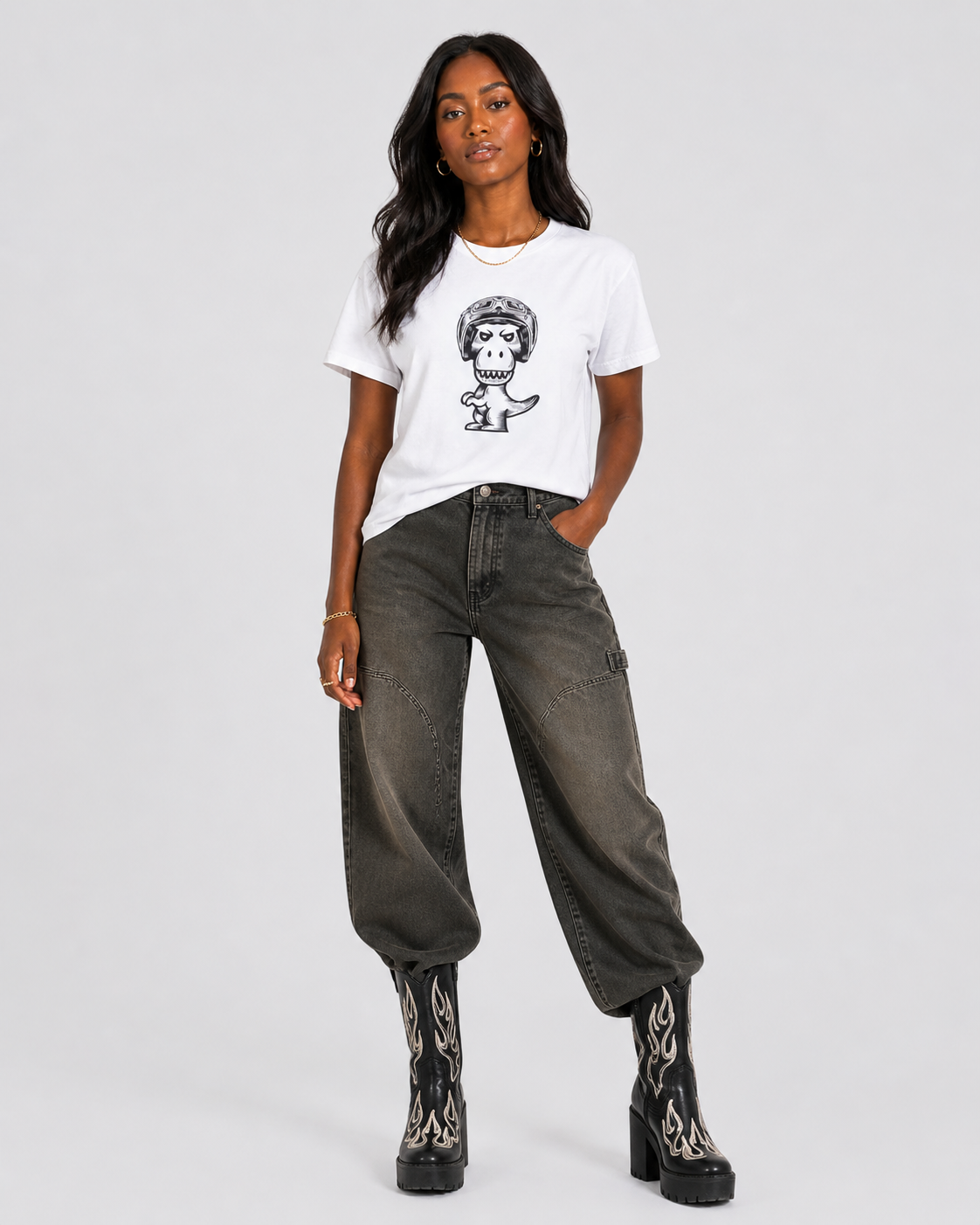 Woman wearing white Regno T-Rex Birota pima cotton tee styled with wide leg cargo pants and flame boots, bold NYC streetwear female outfit