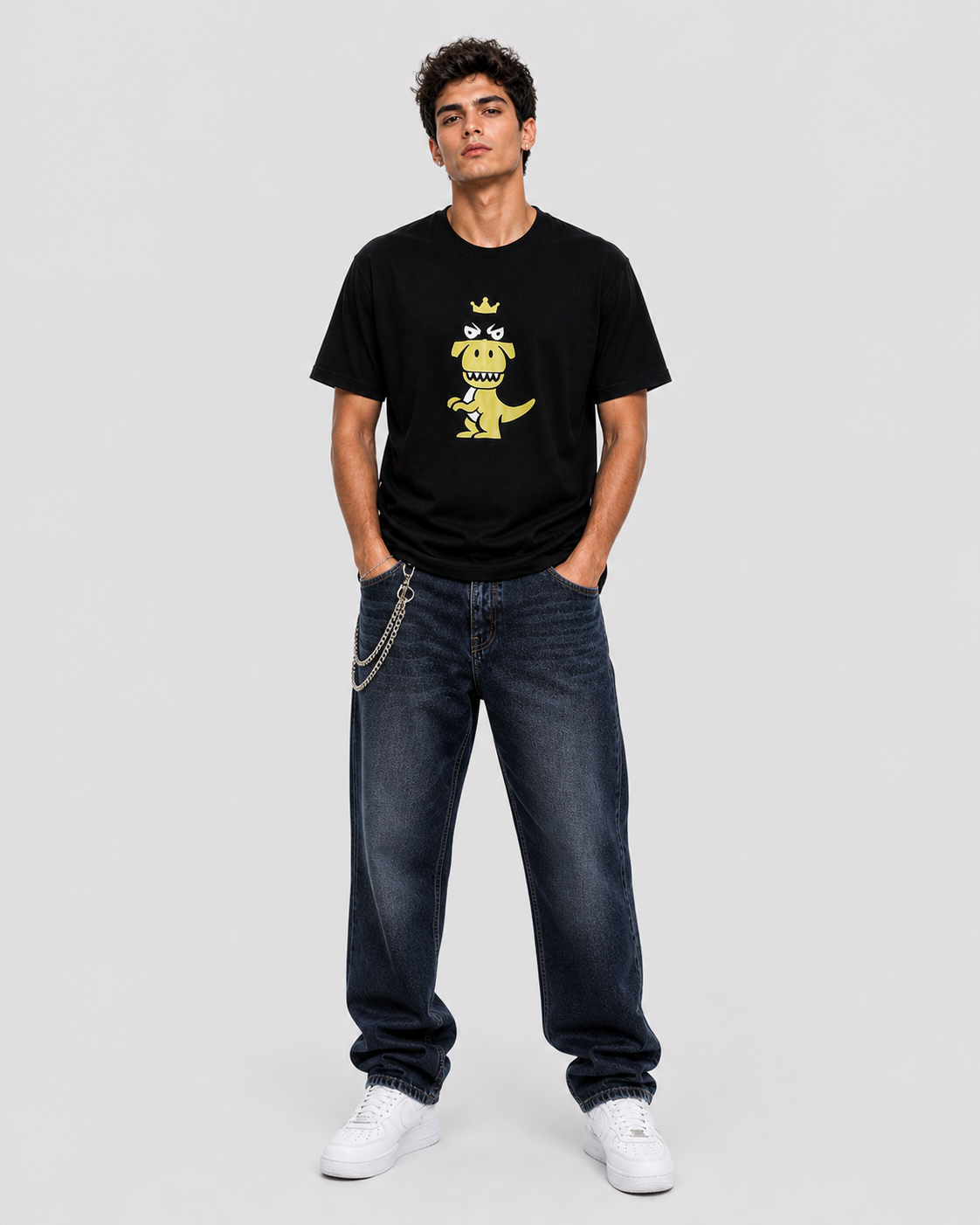 Man wearing black Regno T-Rex Latro pima cotton t-shirt with lime green graphic and black stripe, full body lifestyle shot