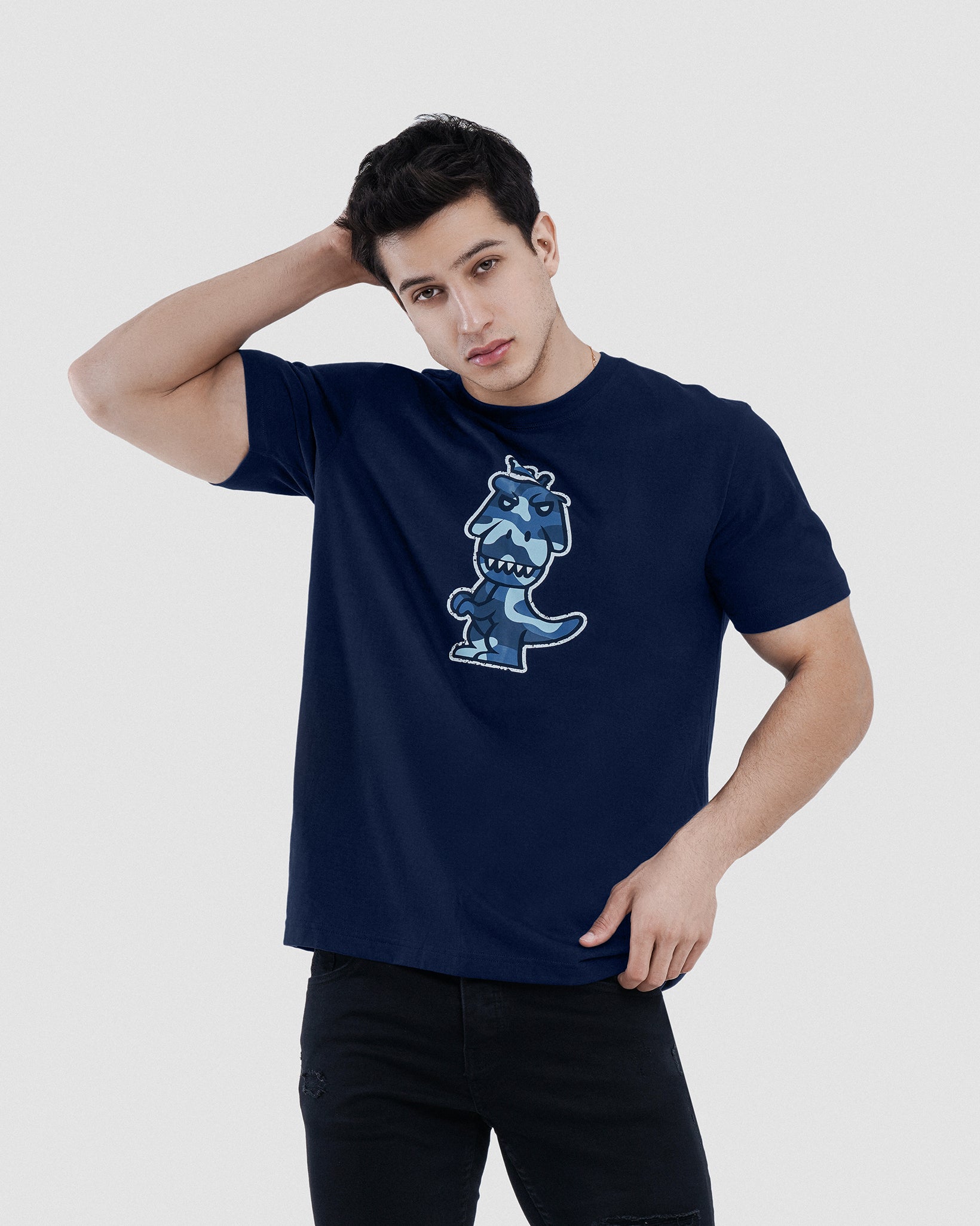 Man wearing navy blue Regno T-Rex Aeris pima cotton graphic tee with blue camo T-Rex design, upper body shot