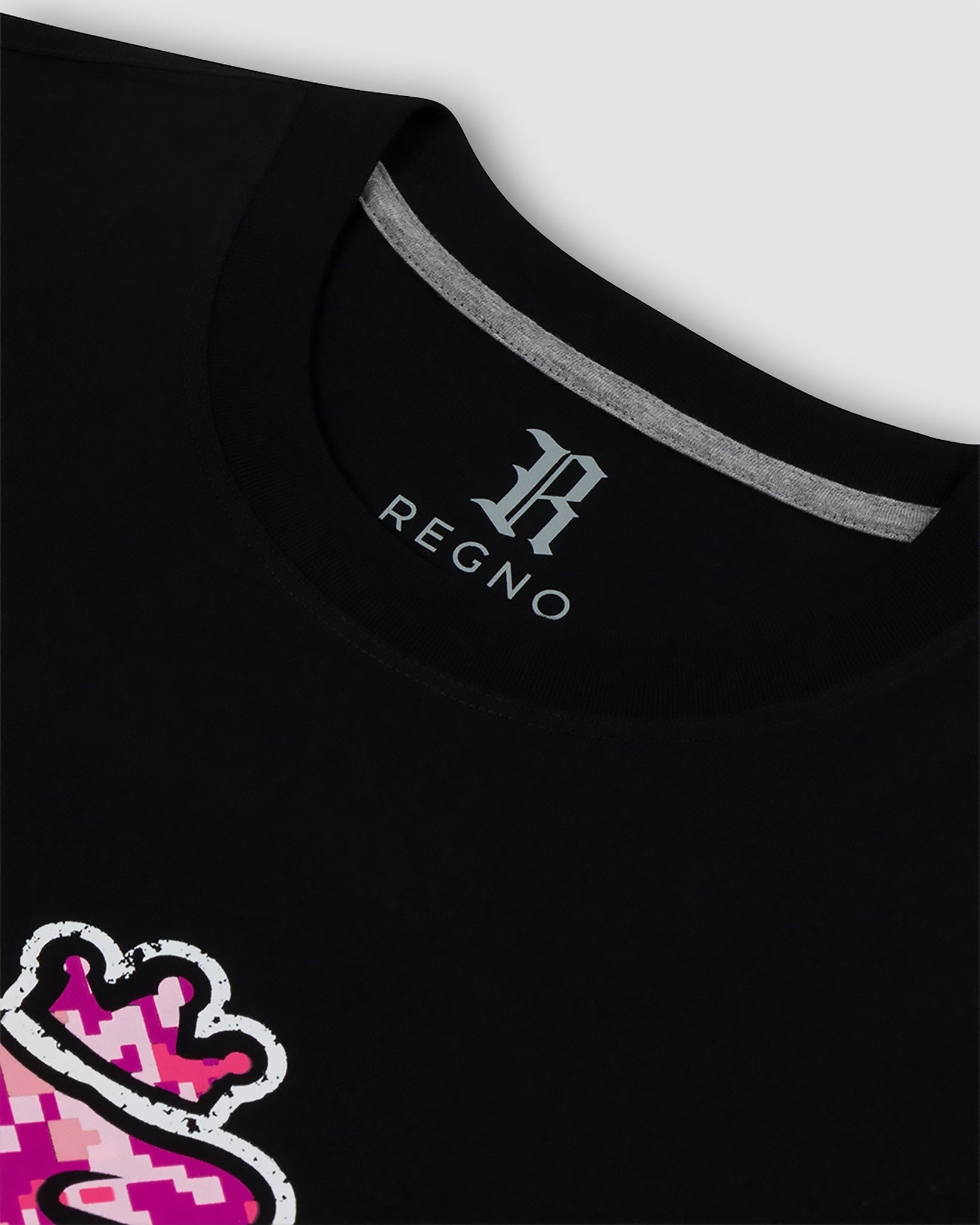 Close-up of pink pixel arcade T-Rex graphic on black pima cotton t-shirt by Regno, detail shot