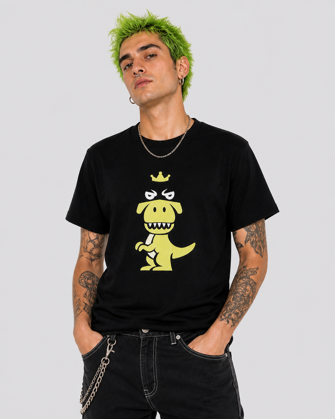 Man with green hair wearing black Regno T-Rex Latro pima cotton tee with lime green T-Rex graphic, bold NYC streetwear male lifestyle shot