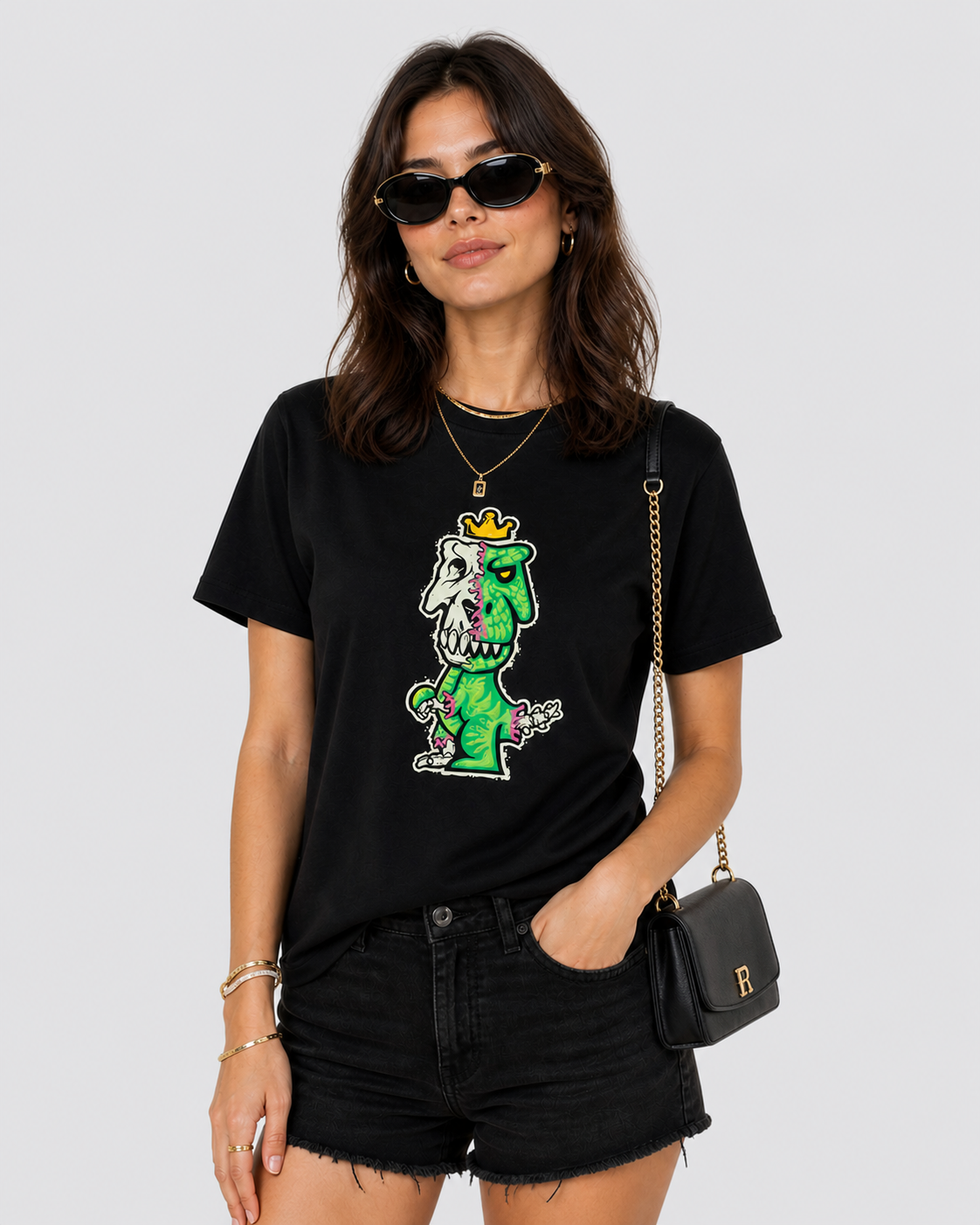 Woman styling black Regno T-Rex Osium pima cotton tee with black denim shorts, gold jewelry and sunglasses, NYC streetwear outfit