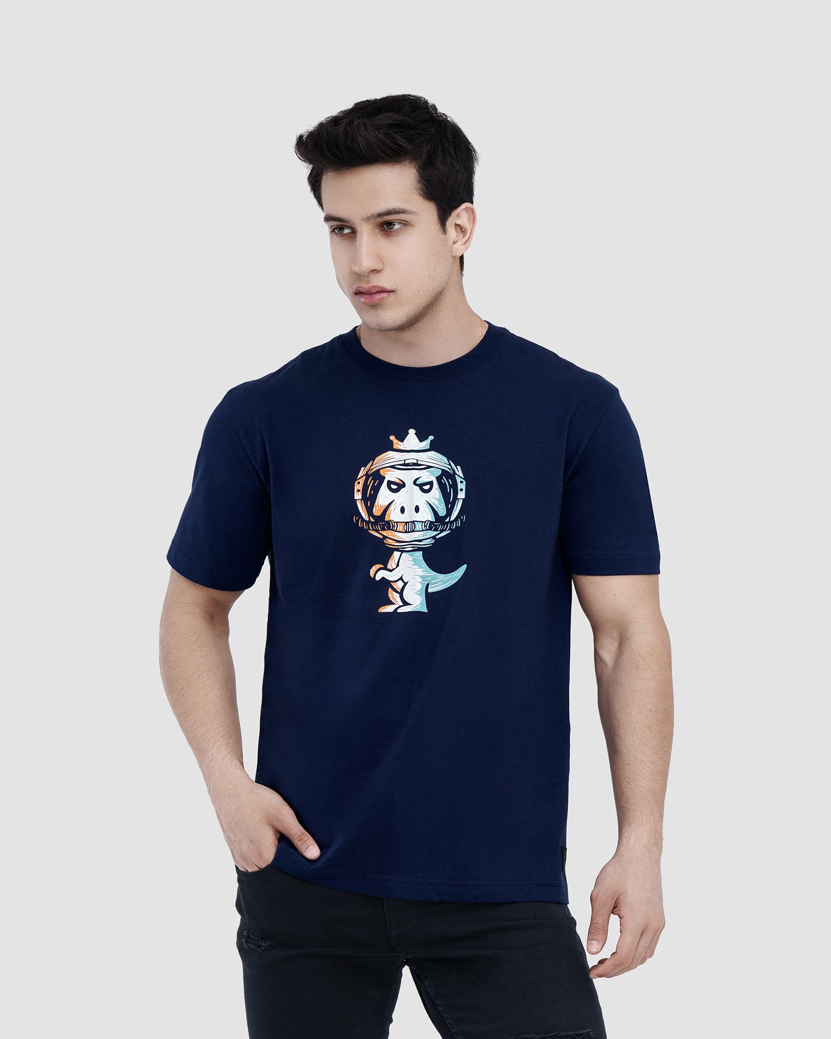 Man wearing navy blue Regno T-Rex Astro pima cotton graphic tee with cosmic astronaut T-Rex design, upper body shot