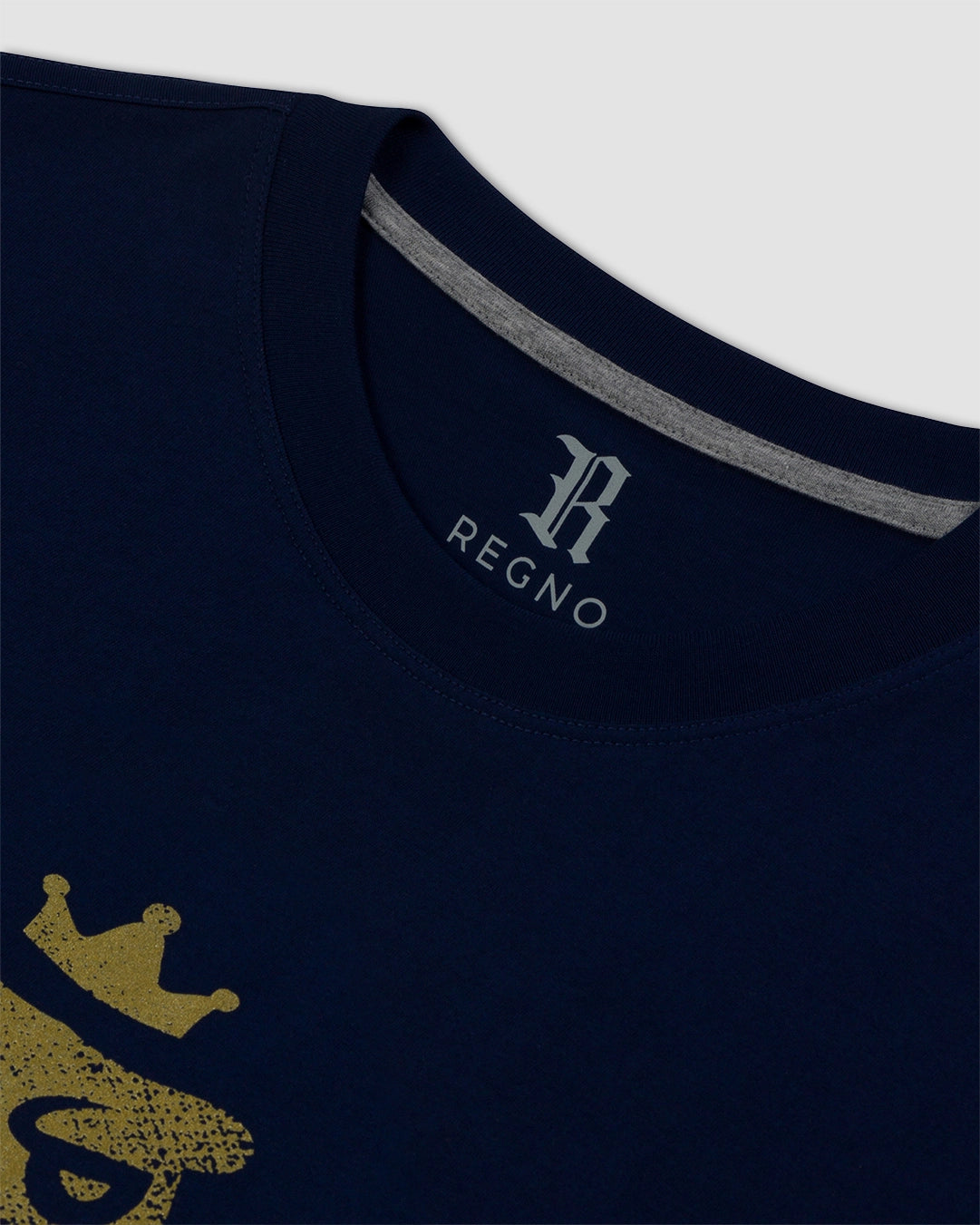 Close-up of vintage gold T-Rex graphic on navy pima cotton t-shirt by Regno, detail shot