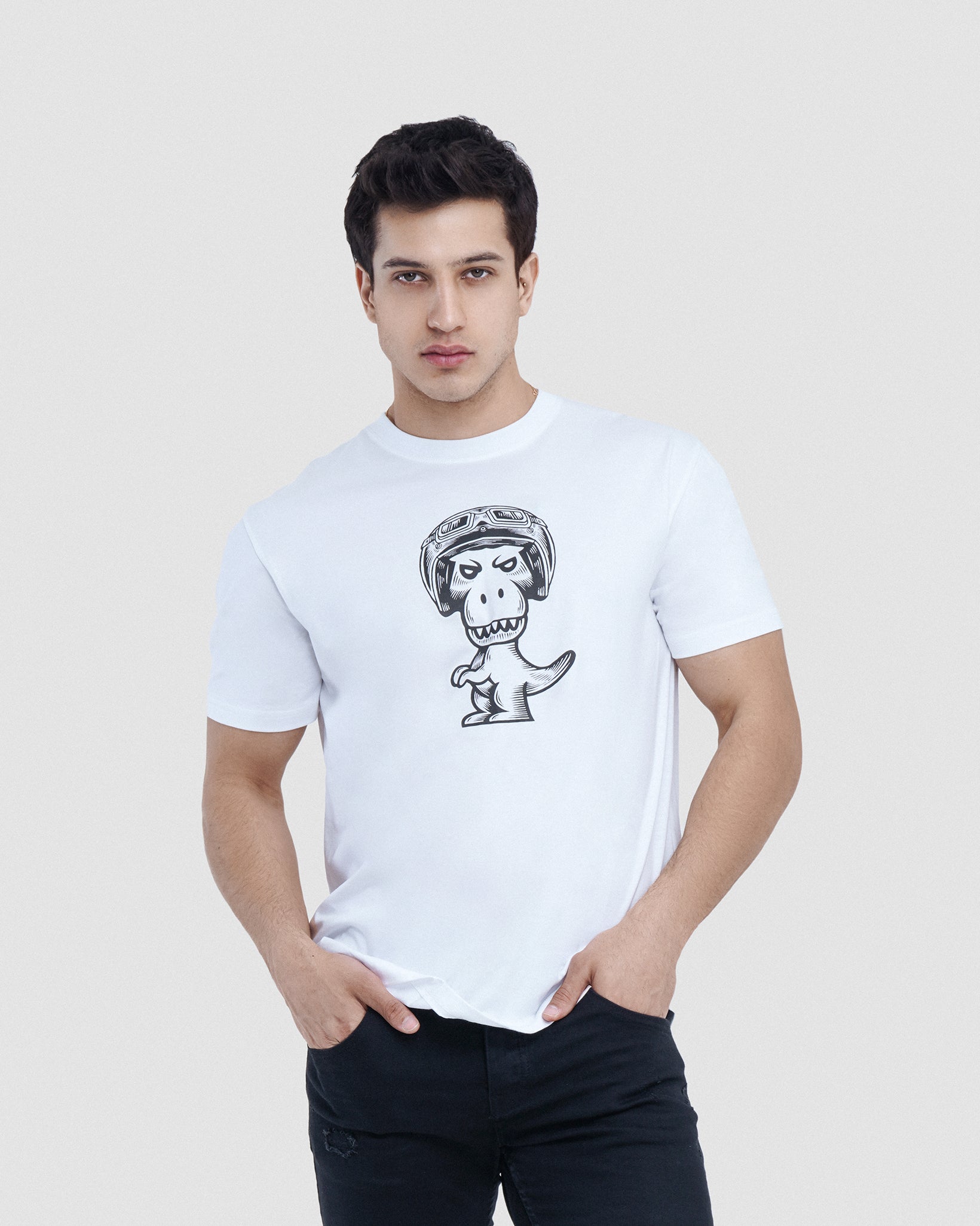Man wearing white Regno T-Rex Birota pima cotton graphic tee with black racing helmet T-Rex design, upper body shot